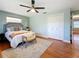 Main bedroom with hardwood floors, ceiling fan and en-suite bathroom at 2446 Belleair Rd, Clearwater, FL 33764