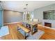 Bright dining room with wood floors, a wood table, and built-in shelving at 2446 Belleair Rd, Clearwater, FL 33764