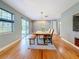 Bright dining room with hardwood floors and sliding glass doors to backyard at 2446 Belleair Rd, Clearwater, FL 33764
