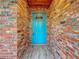 Charming teal front door entryway with brick walls at 2446 Belleair Rd, Clearwater, FL 33764