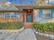 Inviting front entrance with teal door and brick columns at 2446 Belleair Rd, Clearwater, FL 33764