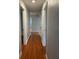 Long hallway with hardwood floors and neutral walls at 2446 Belleair Rd, Clearwater, FL 33764