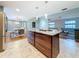 Open kitchen with large island, stainless steel appliances, and granite countertops at 2446 Belleair Rd, Clearwater, FL 33764