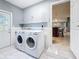 Convenient laundry room with washer, dryer, and access to kitchen at 2446 Belleair Rd, Clearwater, FL 33764