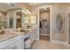 Elegant bathroom with double vanity, walk-in shower, and large closet at 29555 Zupetta Ln, Wesley Chapel, FL 33545