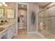 Elegant bathroom with double vanity, walk-in shower, and large closet at 29555 Zupetta Ln, Wesley Chapel, FL 33545