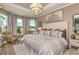 Spacious primary bedroom with large windows and sitting area at 29555 Zupetta Ln, Wesley Chapel, FL 33545