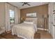 Cozy bedroom with wood-paneled accent wall and ceiling fan at 29555 Zupetta Ln, Wesley Chapel, FL 33545