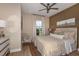 Cozy bedroom with wood-paneled accent wall and ceiling fan at 29555 Zupetta Ln, Wesley Chapel, FL 33545