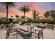Relaxing fire pit area with seating and landscaping at 29555 Zupetta Ln, Wesley Chapel, FL 33545