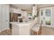 Modern kitchen with white cabinets, stainless steel appliances, and an island at 29555 Zupetta Ln, Wesley Chapel, FL 33545