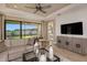 Living room with a large TV and access to a bedroom at 29555 Zupetta Ln, Wesley Chapel, FL 33545