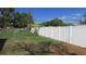 Spacious backyard featuring a white privacy fence, grass and some shrubbery at 3083 55Th N Ave, St Petersburg, FL 33714