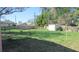 Large backyard with shed enclosed by a wooden fence, ideal for outdoor activities and gardening at 3083 55Th N Ave, St Petersburg, FL 33714