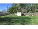 Large backyard with shed enclosed by a wooden fence, ideal for outdoor activities and gardening at 3083 55Th N Ave, St Petersburg, FL 33714