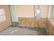 Unfinished basement with concrete floor, stone accent wall, and small window at 3083 55Th N Ave, St Petersburg, FL 33714