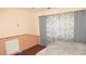 Bedroom featuring wainscoting, wood floor, and a large window with patterned curtains at 3083 55Th N Ave, St Petersburg, FL 33714