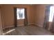 Bright bedroom featuring neutral walls, wood-look flooring, and windows with patterned curtains at 3083 55Th N Ave, St Petersburg, FL 33714