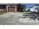 Long driveway leading to a single car garage and backyard with fence at 3083 55Th N Ave, St Petersburg, FL 33714