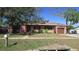 Charming single-story home with a well-maintained lawn, mature trees, and attached one car garage at 3083 55Th N Ave, St Petersburg, FL 33714