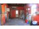 This is an empty garage with an orange paint job, shelving, and a washer at 3083 55Th N Ave, St Petersburg, FL 33714