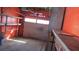 This is an empty garage with an orange paint job and shelving at 3083 55Th N Ave, St Petersburg, FL 33714