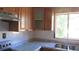 Eat-in kitchen featuring laminate countertops, wood cabinets, and stainless-steel sink at 3083 55Th N Ave, St Petersburg, FL 33714