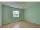 Bright bedroom featuring wood floors and a window with blinds at 3145 Meta Ct, Largo, FL 33771