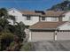 Two-story house with a two-car garage and solar panels at 3145 Meta Ct, Largo, FL 33771