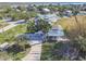 Scenic aerial view of a charming residential neighborhood with lush greenery and glimpses of the nearby ocean at 3476 Tidewater Dr, Weeki Wachee, FL 34607