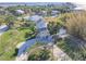 An aerial view of a cozy neighborhood with palm trees and picturesque homes, showcasing the coastal charm at 3476 Tidewater Dr, Weeki Wachee, FL 34607