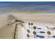 This aerial captures beach shoreline featuring palm trees and shallow waters at 3476 Tidewater Dr, Weeki Wachee, FL 34607