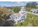 Aerial view of a gray two-story home with an open tower, featuring a screened porch and stairway access at 3476 Tidewater Dr, Weeki Wachee, FL 34607