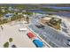 Aerial view of a beach, parking lot, picnic shelters and a view of homes beyond at 3476 Tidewater Dr, Weeki Wachee, FL 34607
