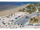 An aerial view of a beach with a parking area, picnic shelters, and lush vegetation at 3476 Tidewater Dr, Weeki Wachee, FL 34607