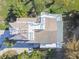 An aerial view of the home featuring multiple decks, a paver driveway, and lush landscaping at 3476 Tidewater Dr, Weeki Wachee, FL 34607