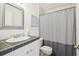Bathroom featuring a tiled countertop, white cabinets, and a shower with a curtain at 3476 Tidewater Dr, Weeki Wachee, FL 34607