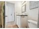 Bathroom with a tiled countertop, white cabinets, and beach decor at 3476 Tidewater Dr, Weeki Wachee, FL 34607