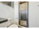 Neutral bathroom featuring tile-walled walk-in shower with glass door and toilet with white seat at 3476 Tidewater Dr, Weeki Wachee, FL 34607