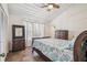 Bedroom with a queen bed, wood dresser, and nautical-themed decor at 3476 Tidewater Dr, Weeki Wachee, FL 34607