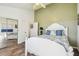 Bedroom featuring a white bed, mirrored closet doors, and a ceiling fan at 3476 Tidewater Dr, Weeki Wachee, FL 34607