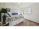 Bedroom featuring coastal decor, tile floors, a ceiling fan, and a large window at 3476 Tidewater Dr, Weeki Wachee, FL 34607