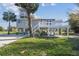 Exterior view of house with stairs and elevated house, and a large grassy lawn at 3476 Tidewater Dr, Weeki Wachee, FL 34607