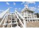Exterior showcasing stairs to the rooftop viewing deck, and the home of this coastal property at 3476 Tidewater Dr, Weeki Wachee, FL 34607