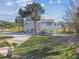 Charming elevated home features lush landscaping, a covered porch, and a paver driveway at 3476 Tidewater Dr, Weeki Wachee, FL 34607