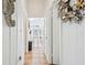 Hallway with tile floors, leading to other rooms, decorated with nautical decor at 3476 Tidewater Dr, Weeki Wachee, FL 34607