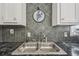 Close up of the kitchen sink with gray backsplash at 3476 Tidewater Dr, Weeki Wachee, FL 34607