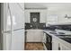 Efficient kitchen with white cabinets and black countertops at 3476 Tidewater Dr, Weeki Wachee, FL 34607