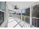 Relaxing screened porch offering an outdoor ceiling fan and beautiful views of the surrounding landscape at 3476 Tidewater Dr, Weeki Wachee, FL 34607