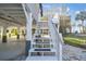 Outdoor stairs going up to elevated home with underneath covered parking at 3476 Tidewater Dr, Weeki Wachee, FL 34607
